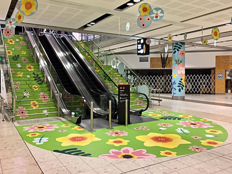 Printed floral floor graphics on a shopping centre concourse