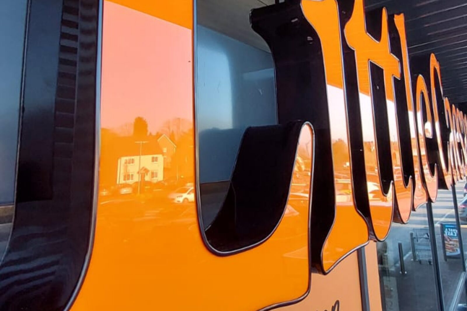 Close-up of orange built-up acrylic letters