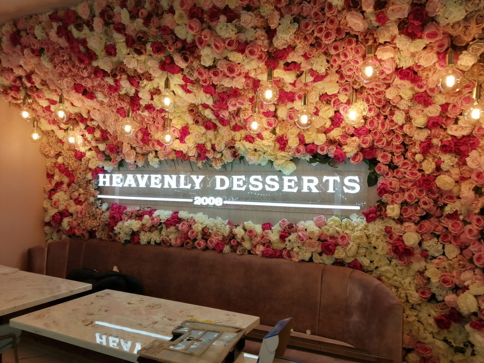 Heavenly Desserts illuminated interior sign and flower wall